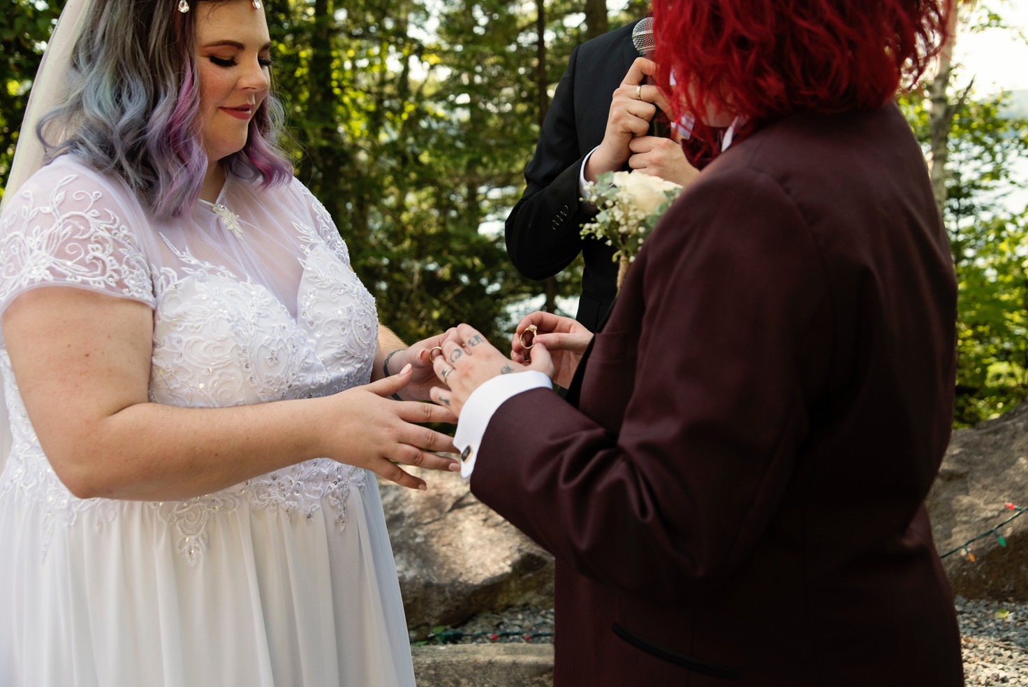 Lesbian brides exchanging rings at LGBTQ+ wedding ceremony.